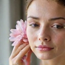 Image representing women's skincare, perhaps a delicate flower or a woman's serene face.
